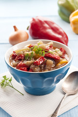 Colorful vegetable stew in a blue bowl