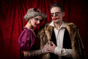 Beautiful vampires couple woman and man in medieval clothes