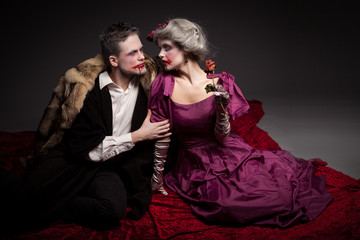 Beautiful vampires couple woman and man in medieval clothes