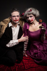 Beautiful vampires couple woman and man in medieval clothes