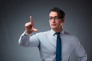 Handsome businessman pressing virtual buttons