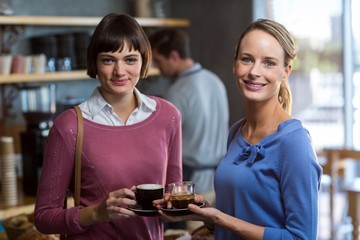 Female friends interacting while having coffee
