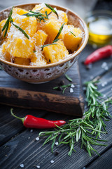 Crunchy croutons in bowl with rosemary