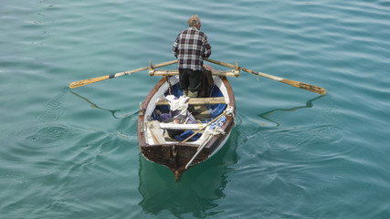 Obraz premium Fisherman with his boat goes fishing