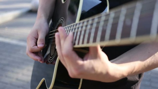 Guitarist Playing on Acoustic Guitar on Street