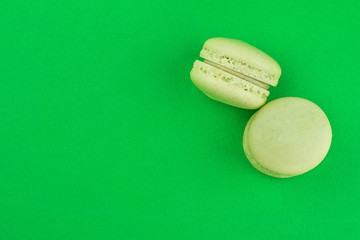 two green cake macaron on green background, maccarone sweet dessert