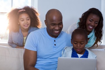 Happy family using laptop