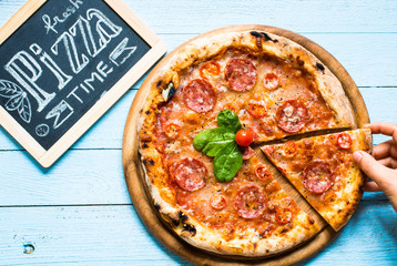 Hot Italian pizza on a rustic wooden table.
