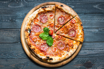 Hot Italian pizza on a rustic wooden table.