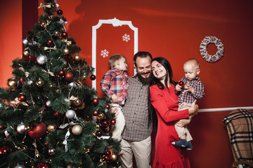 Christmas family portrait in home holiday living room, kids and baby with parents, decorating house...