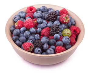 Brown ceramic plate with berries isolated on the white background with clipping path