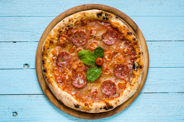 Hot Italian pizza on a rustic wooden table.