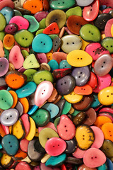 background of colorful buttons made with dried palm seeds