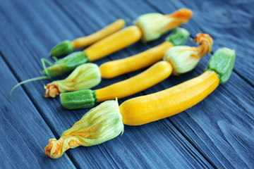 Fresh yellow zucchini on wooden background