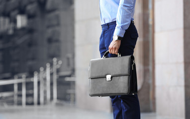 Lawyer holding briefcase on the street