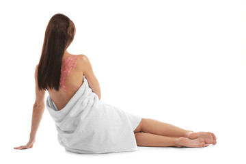 Fototapeta premium Young woman with nourishing scrub on back sitting on white background