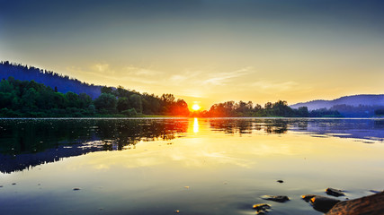 Fototapeta premium Summer sunset over idyllic river landscape