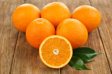 Fresh oranges on wooden table