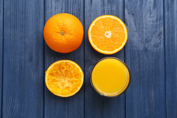 Oranges with juice on wooden table