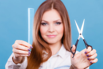 Female hairdresser presenting tools.