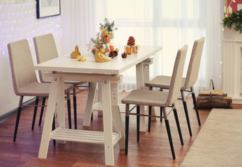 Room with table and chairs decorated for Christmas