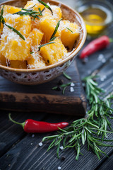 Crunchy croutons in bowl with rosemary