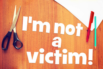 Affirmation I am not a victim on the desk. Concept of positive thinking