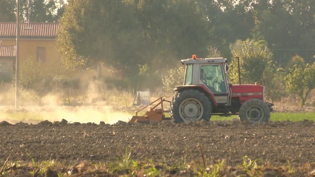 tractor plowing a field in the plains before winter