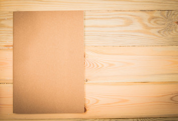 Close note book on wooden background