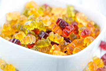 Wooden table with Gummy Bears (selective focus)