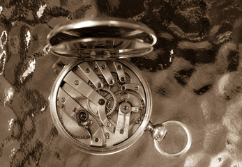 A closeup of a mechanism of an antique Swiss pocket watch.