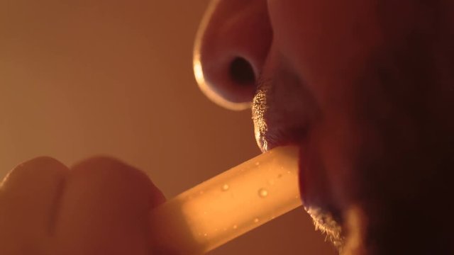young bearded man smokes a hookah extreme close-up