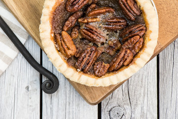 Caramel pecan pie. Thanksgiving dessert. Tart. Rustic style.