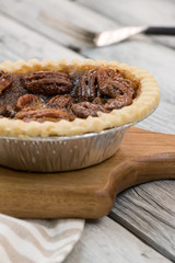 Homemade pecan pie. Thanksgiving menu. Pecan tart on the wooden table.