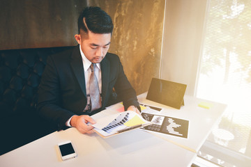 Fototapeta na wymiar Young asian businessman working on home office.