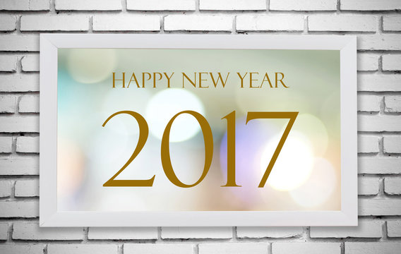 White wooden frame with Happy New Year 2017 on white brick wall