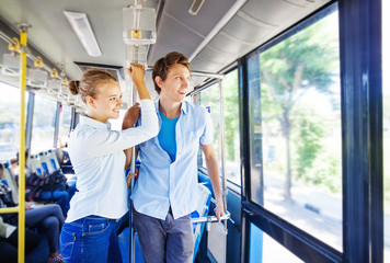 man and woman traveling by bus