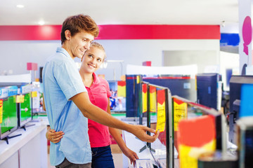 couple choosing tv in a shop