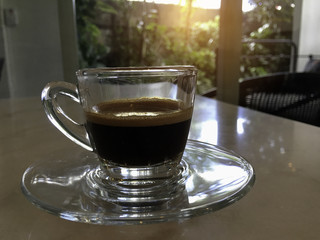 Glass of hot Americano on the table