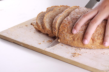 cutting a bread isolated on white background