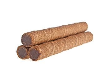 Wafer roll with chocolate and cocoa coating on a white backgroun