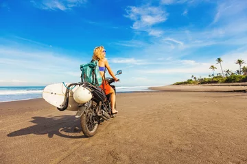 Poster wonderful trip - woman riding a motorcycle with the surfboard © Mila Supinskaya 