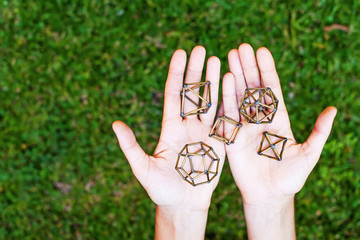 Hands holding sacred geometry