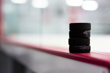Hockey pucks along the boards