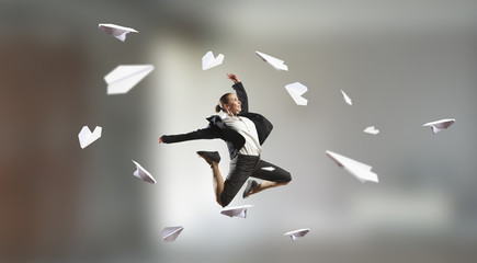 Dancing businesswoman in office . Mixed media