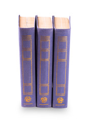 purple three old books standing vertically isolated on white