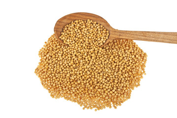 Yellow mustard seeds in wooden spoon isolated on white backgroun