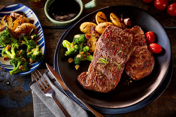 Top down view on steak pieces with vegetables