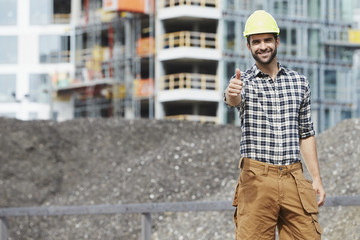 Thumbs up construction worker, smiling