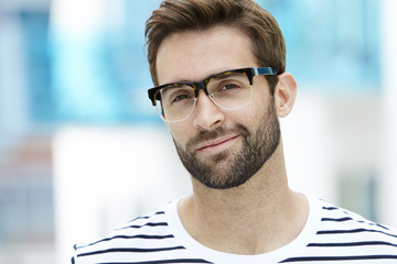 Man with stubble wearing spectacles, portrait